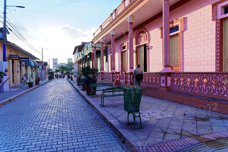 Baracoa, Cuba, Central America, colorful colonial buildings and a paved street under a clear sky, Greater Antilles, Caribbean, America, Central America