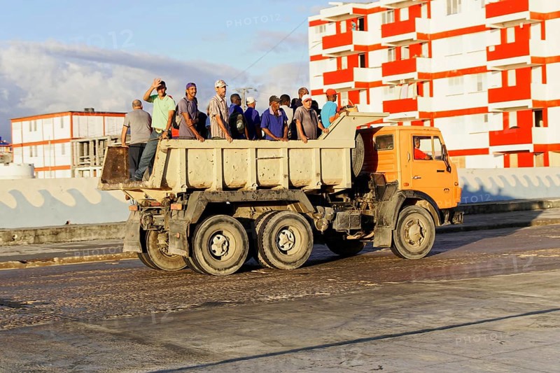 Baracoa, Cuba, Central America, Open truck loaded with workers on a wide, empty road, Greater Antilles, Caribbean, America, Central America