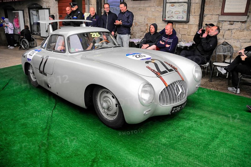 Silver Mercedes gullwing door with race number in a narrow alley at a classic car rally, spectators up close, Mille Miglia 2016, time control, checkpoint, SAN MARINO, classic car race. San Marino, Italia
