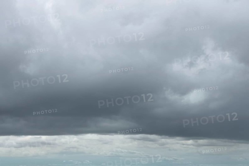 Large cloud field in front closed cloud cover from low-hanging low-hanging Nimbostratus gray blue-gray bad weather cloud, international