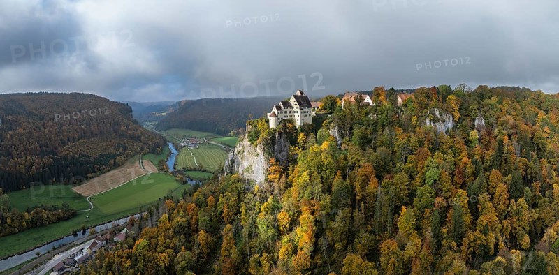 Aerial view, panorama of Werenwag castle and former castle on a rocky spur in the upper Danube Valley, surrounded by autumnal vegetation and clouds of fog, Sigmaringen district, Baden-Württemberg, Germany