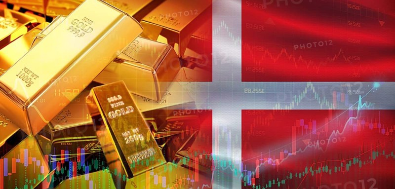 Gold bars stacked on Danish flag. Denmark gold reserves, Concept