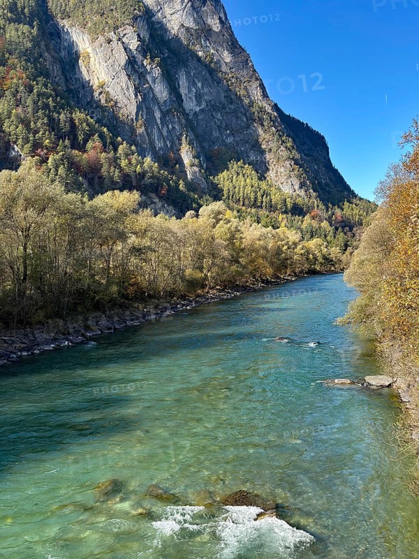 A lively river flows between steep mountains, surrounded by autumn leaves, Drau, Drauradweg, near Lienz, Tyrol, Austria