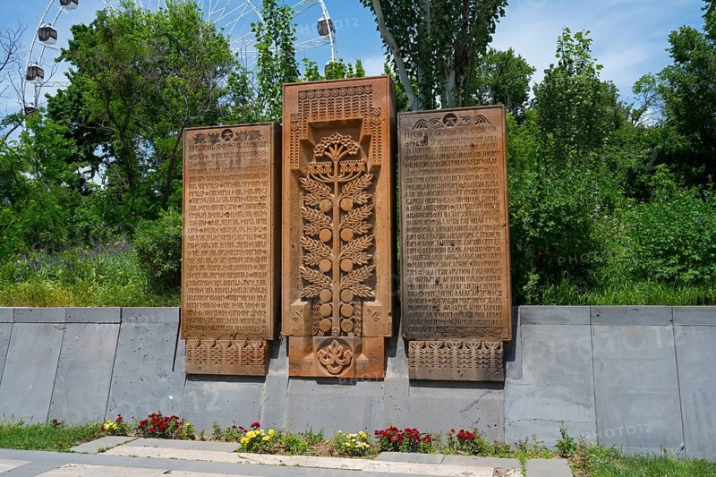Detailed stone monuments in the open air and surrounded by trees, memorial plaques on Heroes' Alley in Victory Park, Haghtanak Park, Yerevan, Yerevan, Armenia