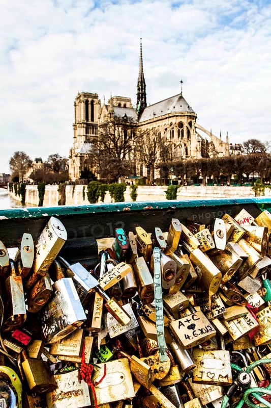 Love padlocks at Pont de l'Archeveche and Notre Dame Cathedral in the background. Paris, France. 02.01.13