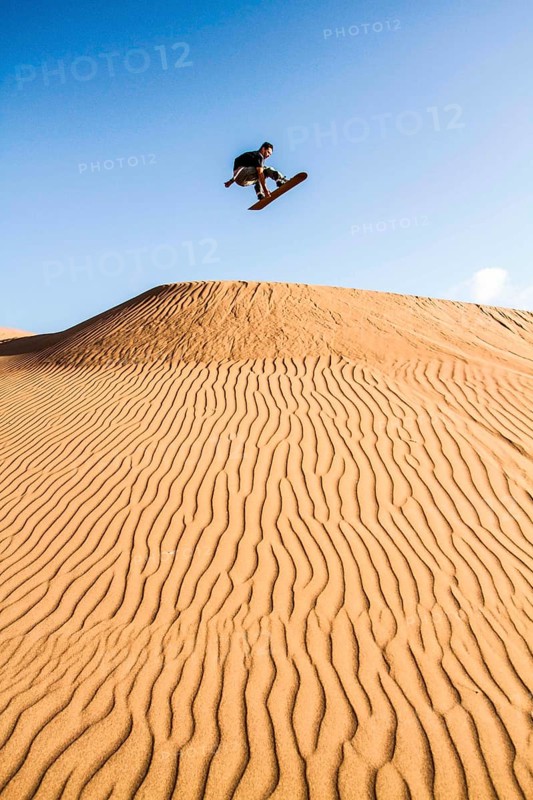 Sandboarding in Cerro Dragon, in Atacama Desert. Iquique, Tarapaca Region, Chile