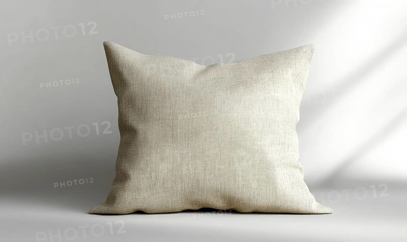 Beige cushion on a gray surface, displaying texture with soft natural light. AI generated