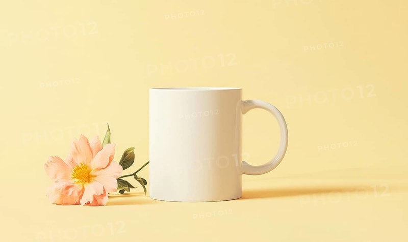 A white coffee cup with a flower on top of it. The flower is pink and the cup is empty. AI generated