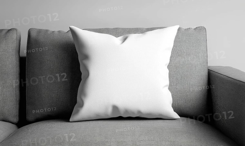 White pillow on a textured gray sofa in a modern setting. AI generated