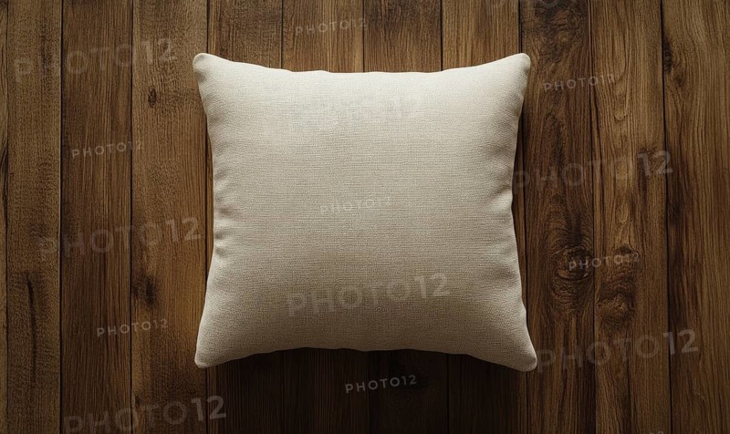 A white pillow sits on a wooden surface. The pillow is unmade and has a simple design. The wooden surface gives the pillow a rustic and natural feel. AI generated
