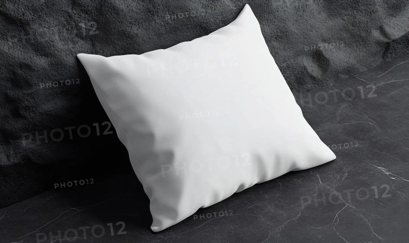 A white pillow against a dark stone surface, highlighting contrast and modern minimalism. AI generated