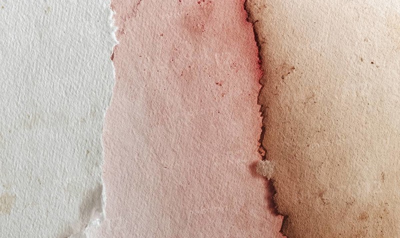 Watercolor texture with torn paper edges, featuring a gradient from pink to brown. AI generated