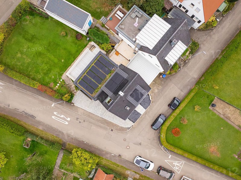 Aerial view of a residential area with house and photovoltaic, green gardens and traffic-calmed street, house renovation, energy renovation, Metzingen, Germany