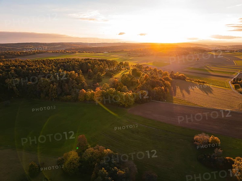 Aerial view of peaceful autumn landscape with sunset in the background, Venusberg, Aidlingen, Germany