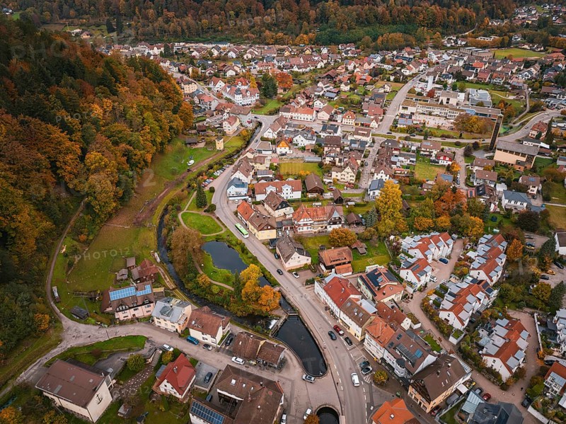 Drone view of an urban landscape with park and watercourse in picturesque autumn scenery, Calmbach, Bad Wildbad, Black Forest, Germany
