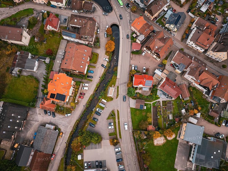 Aerial view of a village from above, showing roads, houses, a river and autumn trees, Calmbach, Bad Wildbad, Black Forest, Germany