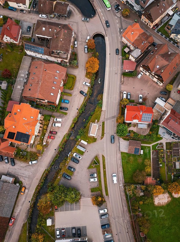Aerial view of a village with a river running between autumn trees and houses, Calmbach, Bad Wildbad, Black Forest, Germany