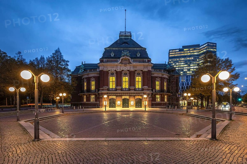 Laeiszhalle, formerly Musikhalle Hamburg, at Johannes Brahms Platz at Blue Hour with light clouds in the background and street lights in the foreground, Hamburg, Germany