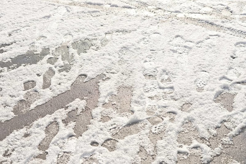 Wheel and foot prints in the fresh snow