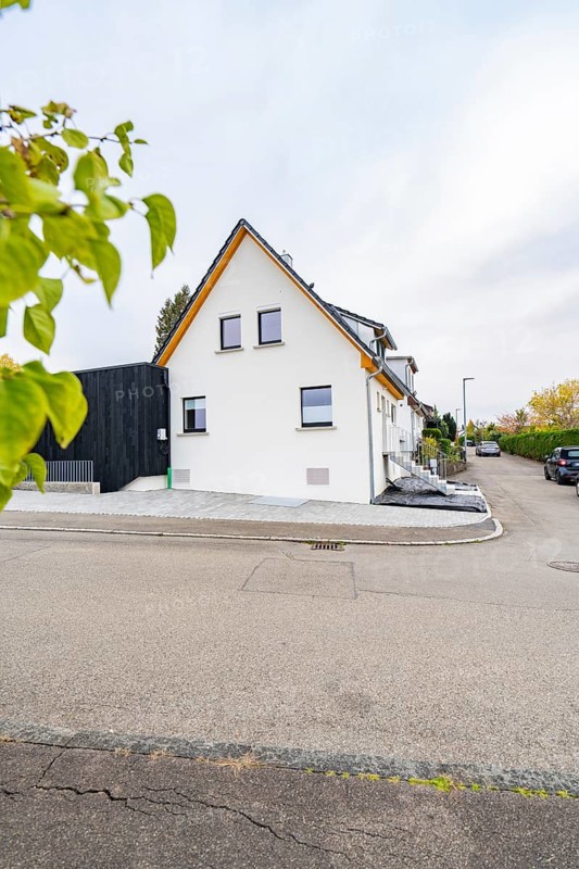 Gable view of a semi-detached house on a quiet residential street with minimalistic design, house renovation, climate renovation, Metzingen, Germany
