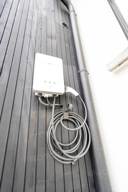White wallbox on black wooden façade, house renovation, climate renovation, Metzingen, Germany