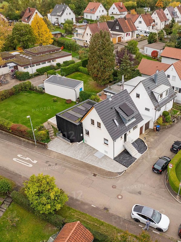 Bird's eye view of a corner house with a modern extension and well-kept garden in a quiet neighborhood, house renovation, climate renovation, Metzingen, Germany