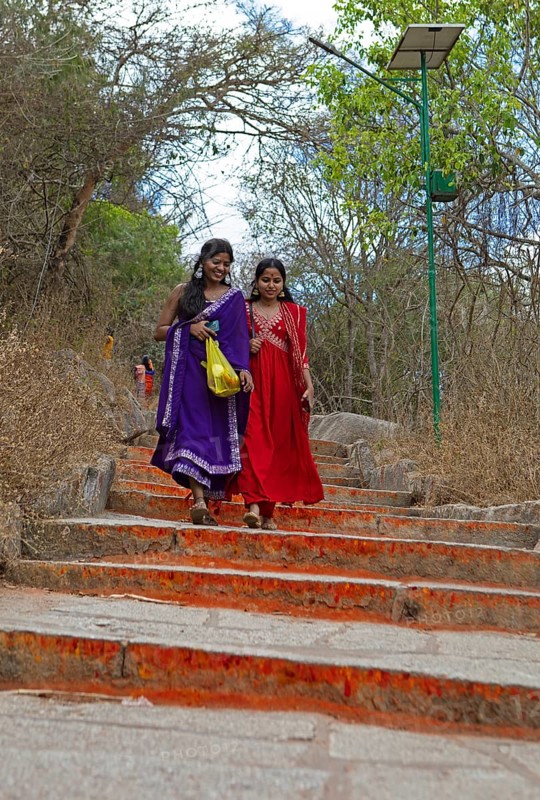 Young Indian woman on the red steps to Chamundi Hill, Mysore or Mysore, Karnataka, India