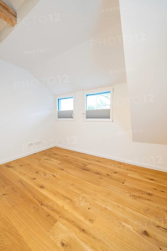 Cosy attic room with warm oak floor and two low windows, house renovation, air conditioning renovation, Metzingen, Germany
