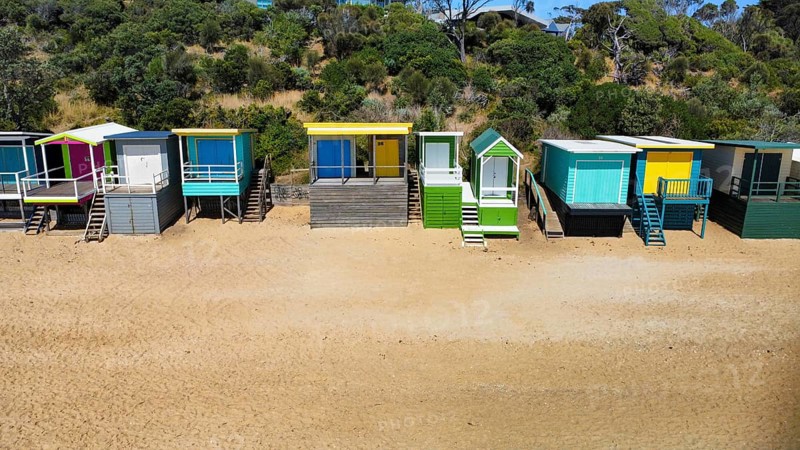 A row of beach houses on a sunny day on an Australian beach, seen from above