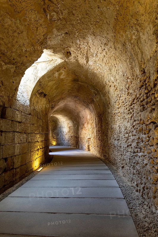 An old historic theatre in the middle of a city. Access tunnel to seats. The ruin was uncovered, Teatro Romano de Cadiz, Andalusia, Spain