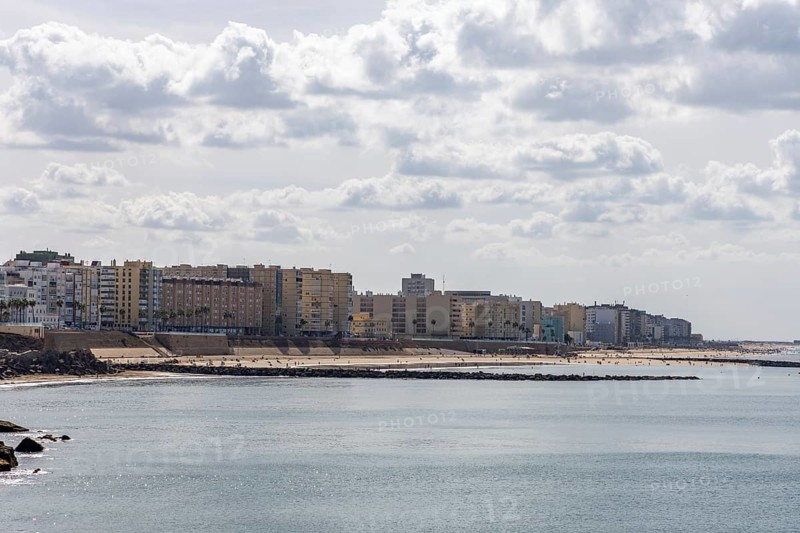An old historic town. The skyline along the city beach and promenade shows its former glory. Cadiz is in the background, Andalusia, Atlantic, Spain
