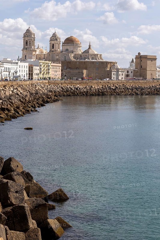 Nice view of a city on the Atlantic coast. A historic old town full of history and life. A beautiful view of the cathedral from the waterfront in Cadiz, Andalucia, Spain