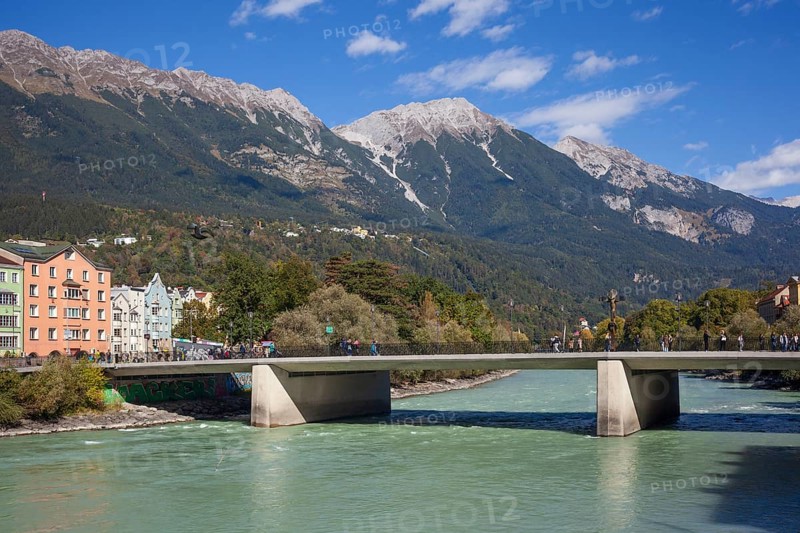 Colourful row of houses in Mariahilfstraße on the Inn River, Inn Bridge and mountains of the Karwendel North Range, Old Town, Innsbruck, Tyrol, Austria