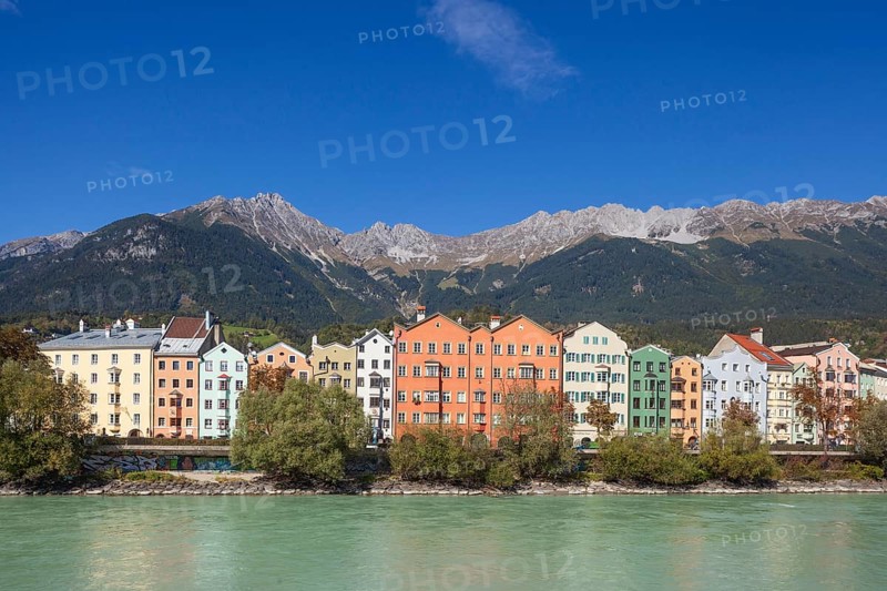 Colourful row of houses in Mariahilfstraße on the Inn River and mountains of the Karwendel North Range, Old Town, Innsbruck, Tyrol, Austria