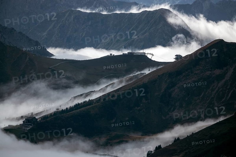 View from the Nebelhorn summit to mountains of the Allgäu Alps, in the middle of Fellhorn Horn with summit station and Kanzelwand cable car summit station, mountains rise from fog in the valley, Oberstdorf, Oberallgäu, Allgäu, Bavaria, Germany