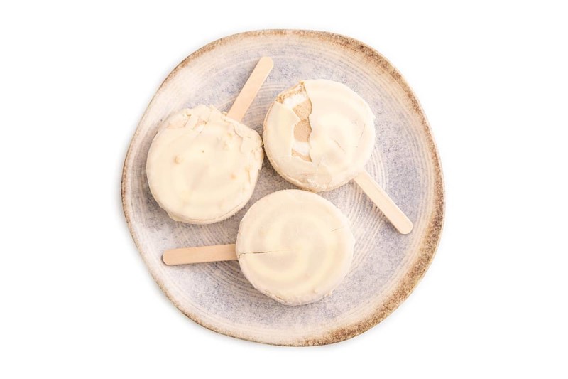 ?hocolate Ice cream in white glaze isolated on white background, top view, flat lay, close up, minimalism