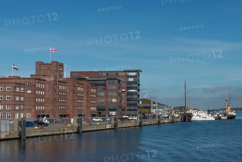 Former warehouse in the port of Kiel, apartments, services, red brick building, architecture, wharf, flags, ships, Kiel Fjord, Schleswig-Holstein, Germany