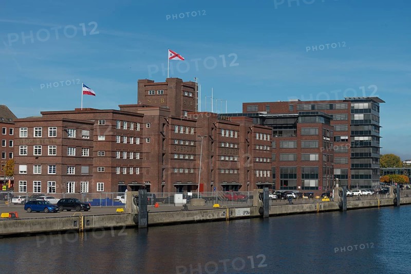 Former warehouse in the port of Kiel, apartments, services, red brick building, architecture, quay, flags, Kiel Fjord, Schleswig-Holstein, Germany