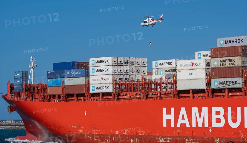 Container ship from the shipping company Hamburg Süd Santa Rita with container and helicopter to release a port pilot leaving the Indian Ocean South Africa Container ship from the shipping company Hamburg Süd Santa Rita with container and helicopter to lower a harbor pilot when leaving the Indian Ocean South Africa