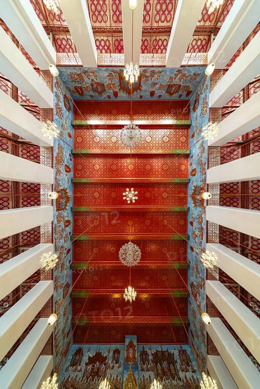 Photo from the frog persective:Ubosot (ordination hall) with columns (Sao) and richly decorated ceiling (Phra Phimarn) and crystal chandeliers, Rattanakosin architecture (Bangkok style), Wat Chana Songkhram, Phra Nakhon, Bangkok, Thailand