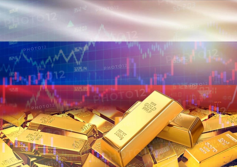 Gold bars on Russia flag in background. Gold bars stacked on Russian flag. Concept of Russia gold reserves