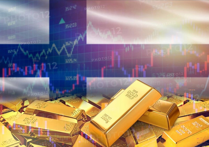 Gold bars on Finland flag in background. Gold bars stacked on Finnish flag. Concept of Finland gold reserves