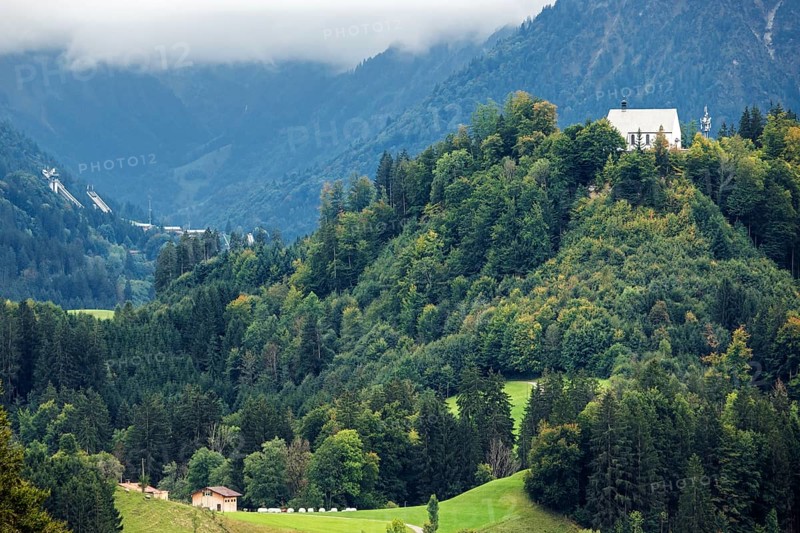 Schöllanger Castle Church, back left ski jumping hills of the Orlen Arena in Oberstdorf, Oberallgäu, Allgäu, Bavaria, Germany