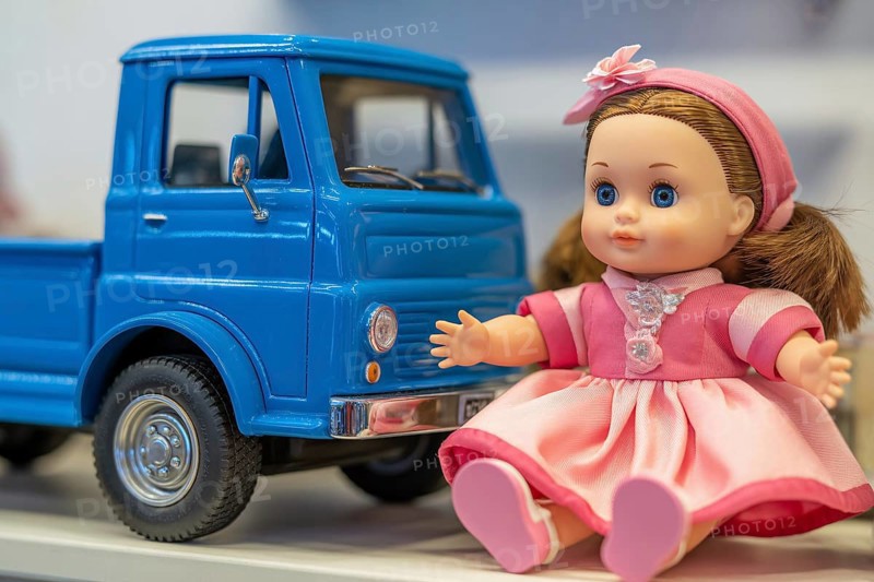 Cute doll in pink dress and blue toy car. Gender stereotypes in children's toys and color coding criticism. Generative AI, AI generated