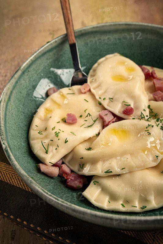 Dumplings, with fried prosciutto, a traditional dish of Polish cuisine, dumplings, top view, close-up, without people