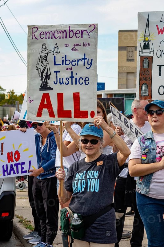 Detroit, Michigan USA - 18 October 2025 - Protesters from Detroit and Grosse Pointe gathered on the border between their cities for a 'No Kings' rally, protesting President Trump's actions against immigrants and against democratic institutions