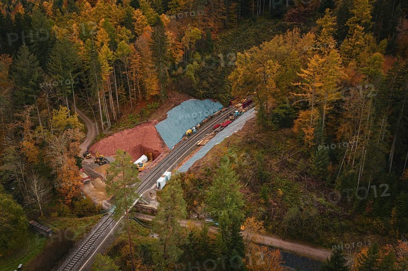 Railway tunnel construction in an autumn forest environment seen from the air, Hermann-Hesse-Bahn construction site, Calw, Germany