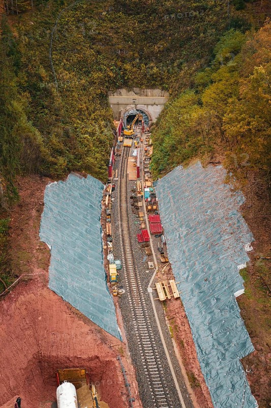 Rail construction in the forest with tunnel opening, surrounded by autumn leaves, Hermann-Hesse-Bahn construction site, Calw, Germany
