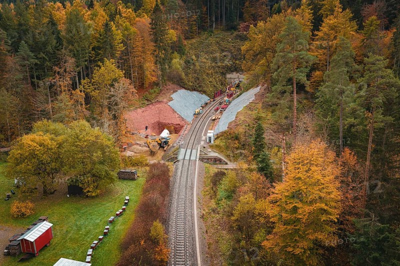 Route of railway tracks in autumn forest landscape with tunnel construction project, Hermann-Hesse-Bahn construction site, Calw, Germany