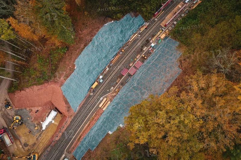 Railway line from above, surrounded by autumn colors, with construction work on the tracks, Hermann-Hesse-Bahn construction site, Calw, Germany